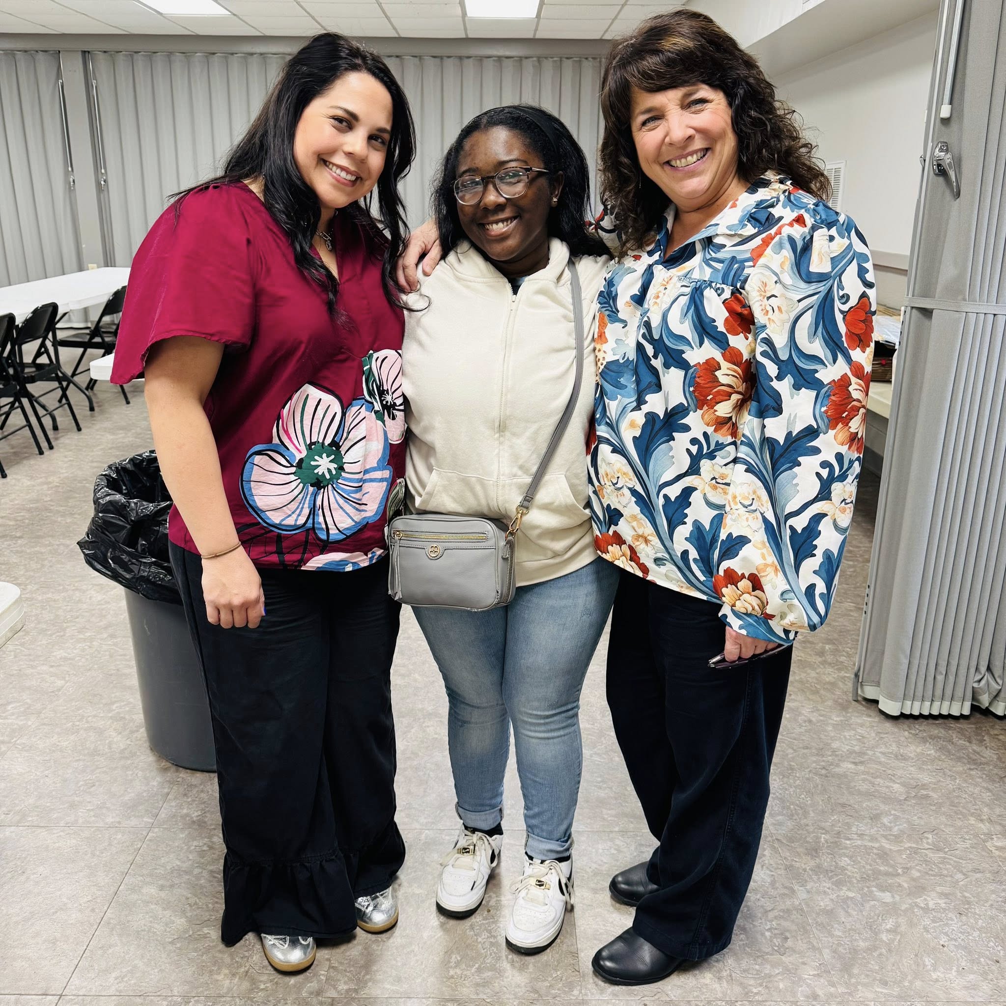 Three ladies posing for a picture.